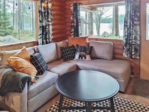 a living room with a couch and a table at Holiday Home Kuusela by Interhome in Soini