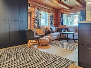 a living room with a couch and a table at Holiday Home Kuusela by Interhome in Soini