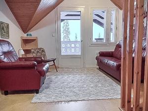a living room with two chairs and a couch at Holiday Home Pallaksen valkkorinne by Interhome in Raattama