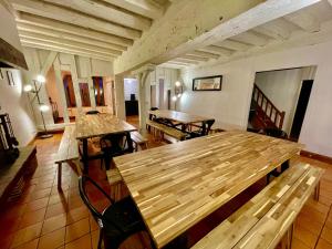 a large room with wooden tables and chairs at villa festive HOMAZING piscine privée 2h de Paris in Choué +32 photos