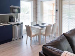 a kitchen and dining room with a table and chairs at Holiday Home Saana 4 by Interhome in Kilpisjärvi +18 photos