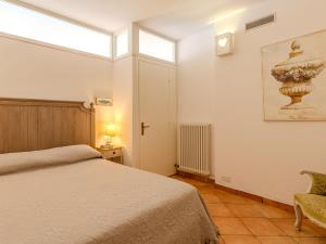 a bedroom with a bed and a vase on the wall at Apartment La Pianca-4 by Interhome in Musso