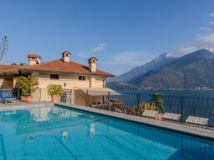 a villa with a swimming pool with a view of the mountains at Apartment La Pianca-4 by Interhome in Musso