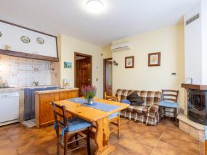 a kitchen and living room with a table and a couch at Holiday Home Ca de Isodor by Interhome in Glori