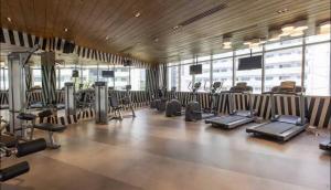a gym with a bunch of treadmills and machines at Tranquil in Manila