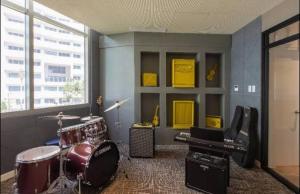 a music room with a drum set and a keyboard at Tranquil in Manila
