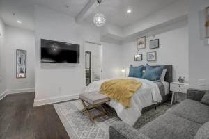 a bedroom with a bed and a couch and a tv at Studio9Forty in Atlanta