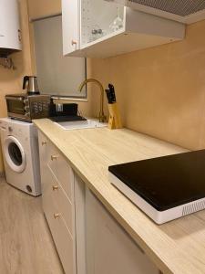 a kitchen with a counter top with a laptop on it at Mediterraneo Euroviajeros Room in Pineda de Mar