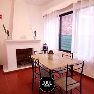 a dining room with a table and chairs and a fireplace at Good Hostel in San Miguel de Allende