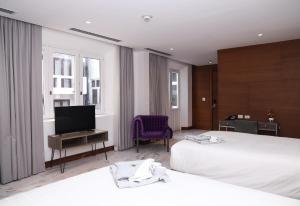 een hotelkamer met 2 bedden en een flatscreen-tv bij Hotel San Felipe in Panama-Stad