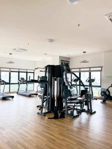 a gym with several treadmills and machines in a room at MFA Putrajaya Homestay in Putrajaya