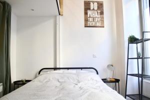 a bedroom with a bed and a poster on the wall at Atypical and design apt JARDIN DES PLANTES in Paris