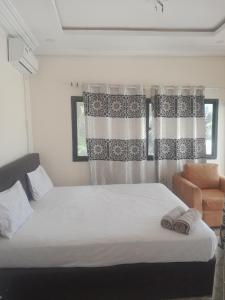 a bedroom with a bed with two towels on it at Smile Gambia Beach Bar in Brufut