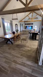 a large living room with wooden floors and a swing at Chambre double chez Audrey in Saligny-sur-Roudon