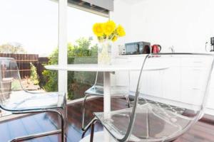 Dos sillas y una mesa con un jarrón de flores. en Modern studio near UCSF/Chase/Oracle Park, en San Francisco 7 fotos más