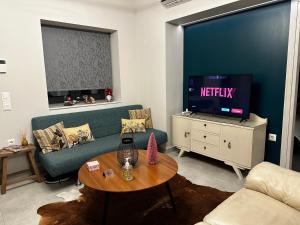 a living room with a couch and a tv at Ponte vecchio apartment in Chalkida