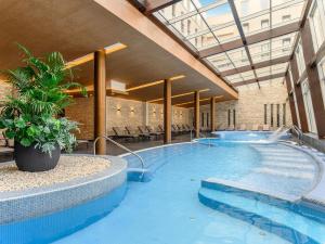 a large swimming pool in a building at Anna Grand Hotel in Balatonfüred