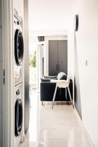 a laundry room with a washer and dryer at ANNA : vue sur les vignes, spa exterieur, sans vis-a-vis in Goudargues