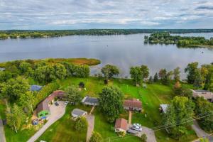 an aerial view of a house on the shore of a lake at Lakeside Living - BBQ Fun, Boat Deck and Playground in Lakefield