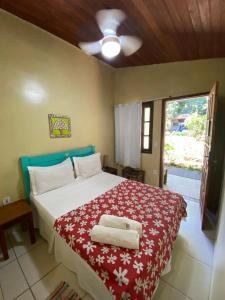 a bedroom with a bed with two towels on it at Chalé Ouro Verde in Angra dos Reis
