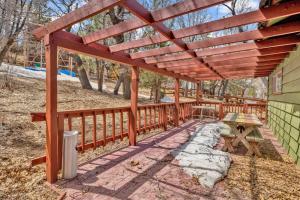 a wooden pergola over a picnic table on a patio at Nestled Oaks Cottage~ Bear Mountain Resort Chalet~ in Big Bear Lake