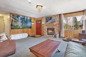 a living room with a fireplace and a couch at Nestled Oaks Cottage~ Bear Mountain Resort Chalet~ in Big Bear Lake