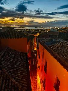 an aerial view of a city at sunset at Castello Attic Sunset Terrace in Cagliari