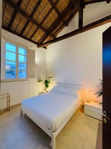 a bedroom with a large white bed in a room at Castello Attic Sunset Terrace in Cagliari