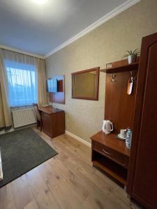 a hotel room with a mirror and a desk and a room at Hotel Arkadia in Końskie