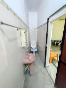 a bathroom with a pink sink in a room at Divisha PG House Sharing Beds Only for boys in Bareilly