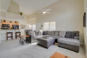 a living room with a couch and a table at Mesquite Condo with Pool and Spa Access, Near Casinos! in Mesquite