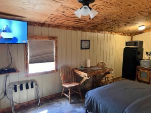 a bedroom with a bed and a desk and a tv at Buddy's Harbor in Lake Ozark