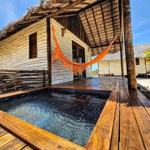 a house with a swimming pool on a wooden deck at São Francisco Ecopousada in Guriú