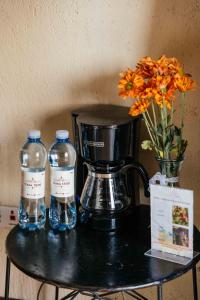 a table with two bottles of water and a blender at Casa 1800 Ataco Hotel Boutique in Concepción de Ataco