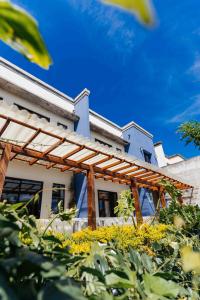 une maison avec une pergola en bois dans l'établissement Casa 1800 Ataco Hotel Boutique, à Concepción de Ataco