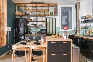 a kitchen with a table and chairs in it at Contemporary T3 in the heart of Bastille Paris - Welkeys in Paris