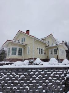 a house is covered in snow at Huvila Lohja in Lohja