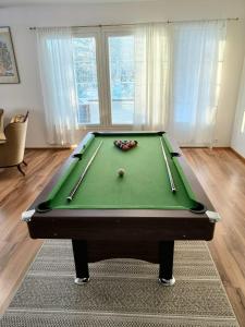 a pool table in a living room with afits at Huvila Lohja in Lohja