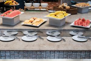 a buffet with plates and fruit on a table at Hilton Colon Guayaquil Hotel in Guayaquil