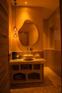 a bathroom with a sink and a mirror at Sahara pearl Hotel in Merzouga