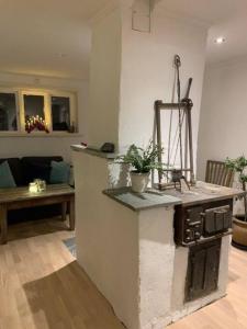 a kitchen with a counter top in a living room at 1800 tals Sjötorp med egen strand och brygga in Åkersberga