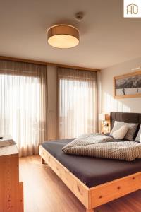a bedroom with a large wooden bed in a room at Haus Percha Mountain Apartments in Perca