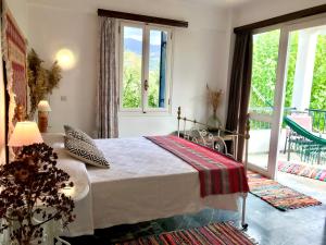 a bedroom with a bed and a large window at Theodora Hotel in Petra