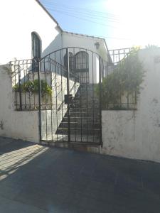 an iron gate on a building with stairs at Hostel Alto Alberdi in Córdoba