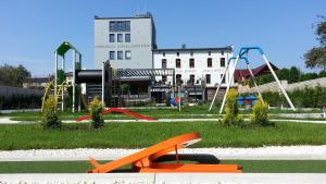 a park with a playground with slides and swings at Stary Młyn in Strzelce Opolskie
