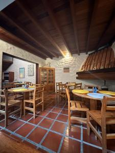 a dining room with wooden tables and chairs at Thalassa Pousada in Arraial do Cabo