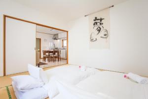 a living room with a white couch and a mirror at Yume House in Niseko
