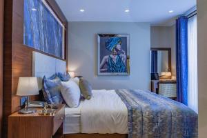 a bedroom with a bed and a table with a lamp at Lord Morgan & Exclusive Design Cihangir in Istanbul