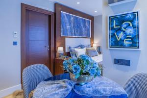 a room with a table with a vase of blue flowers at Lord Morgan & Exclusive Design Cihangir in Istanbul +59 photos