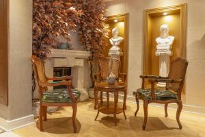 a room with two statues and two chairs and a fireplace at Lord Morgan & Exclusive Design Cihangir in Istanbul
